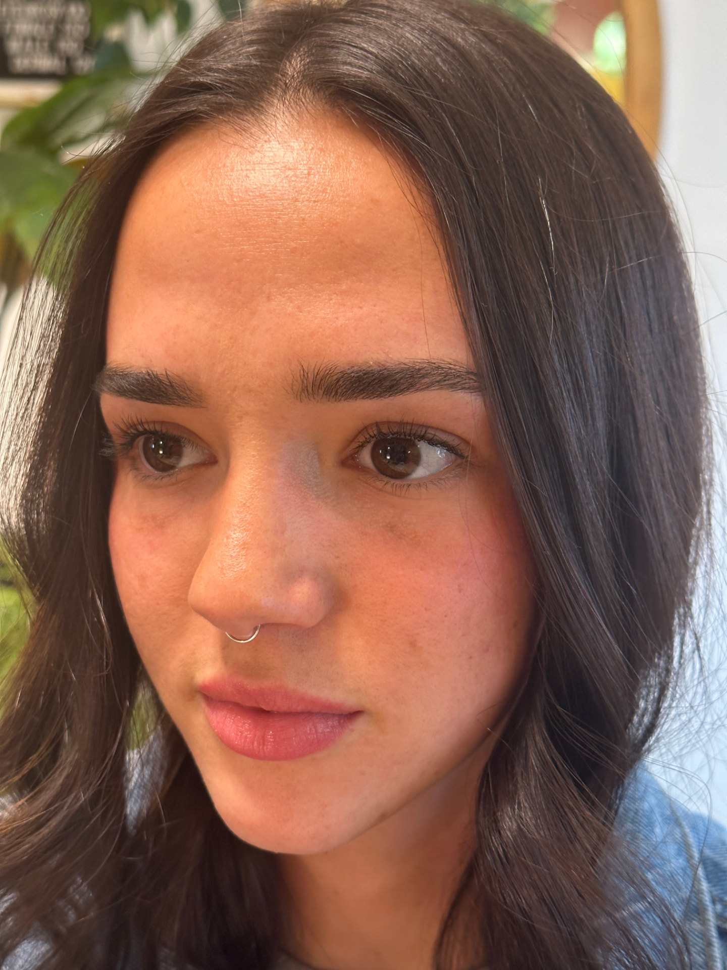 Client with a delicate septum ring in the studio